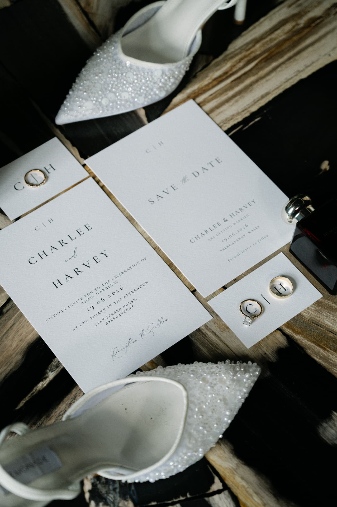 Wedding stationery, rings and bridal shoes styled on wood