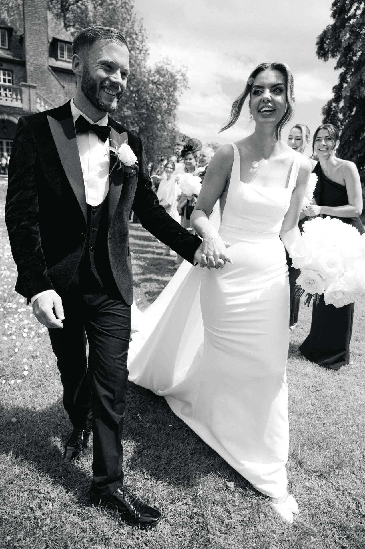 Bride and groom walking through confetti after their ceremony
